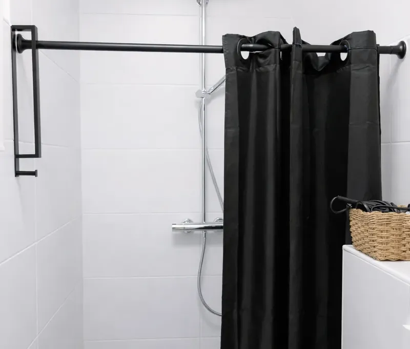Dusche im Ferienhaus Seeblick Dusche im Badezimmer des Ferienhauses Seeblick mit schwarzem Duschvorhang.