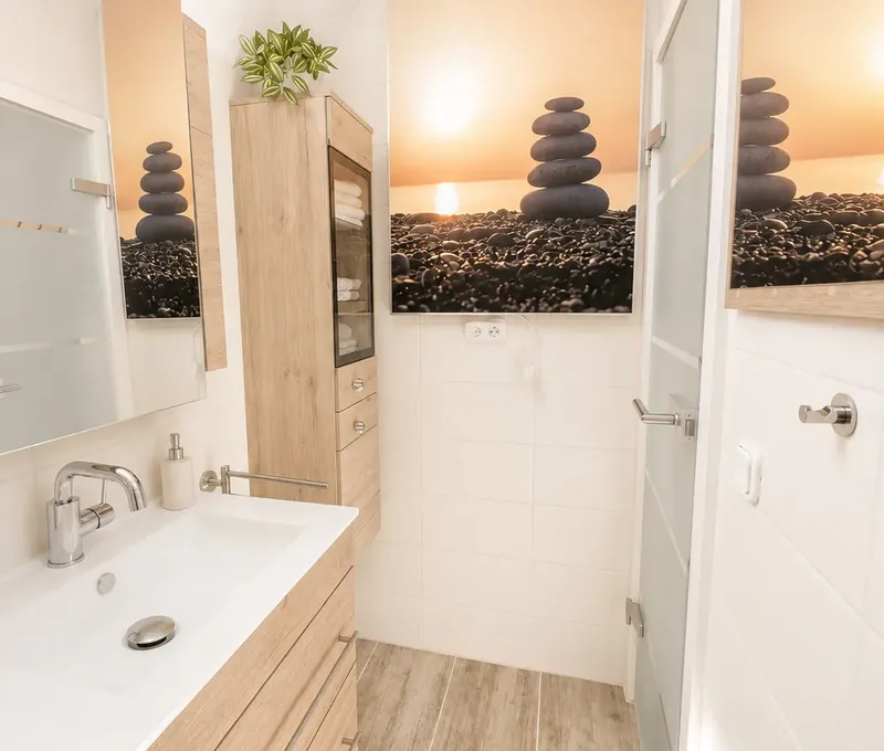 Badezimmer mit Waschbecken im Haus am See Badezimmer im Haus am See mit Waschbecken, Spiegel und Dusche.